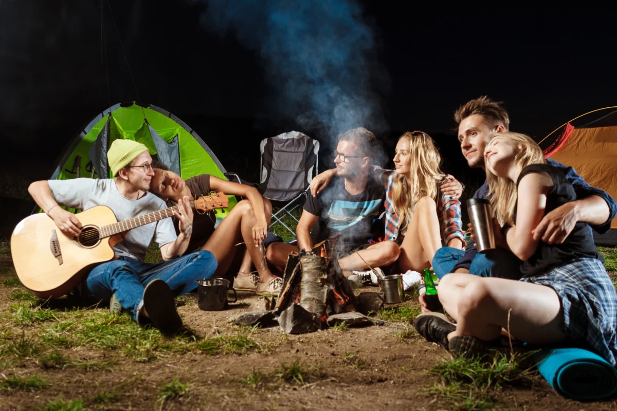 Friends sitting near bofire at bestival 2024